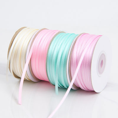 3 มิลลิเมตร สีแคบหลากหลาย สีที่กําหนดเอง ความทนทานสูง พอลิเอสเตอร์ เซตินริบบอนสําหรับการบรรจุของขวัญ